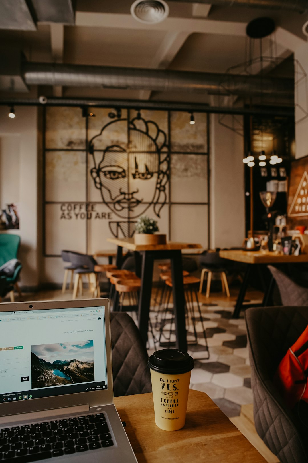 brown-coffee-cup-beside-laptop-p2xo7mvl7bs